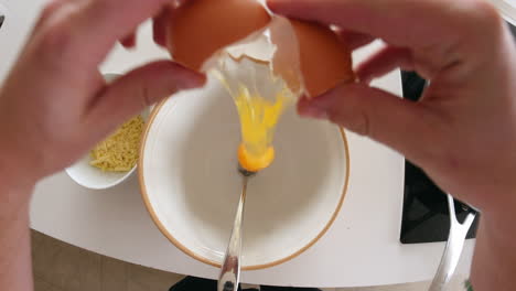 point of view of man preparing ingredients for an omelette