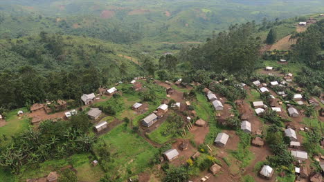 Fast-aerial-flight-over-jungle-village-cut-into-steep-lush-mountain