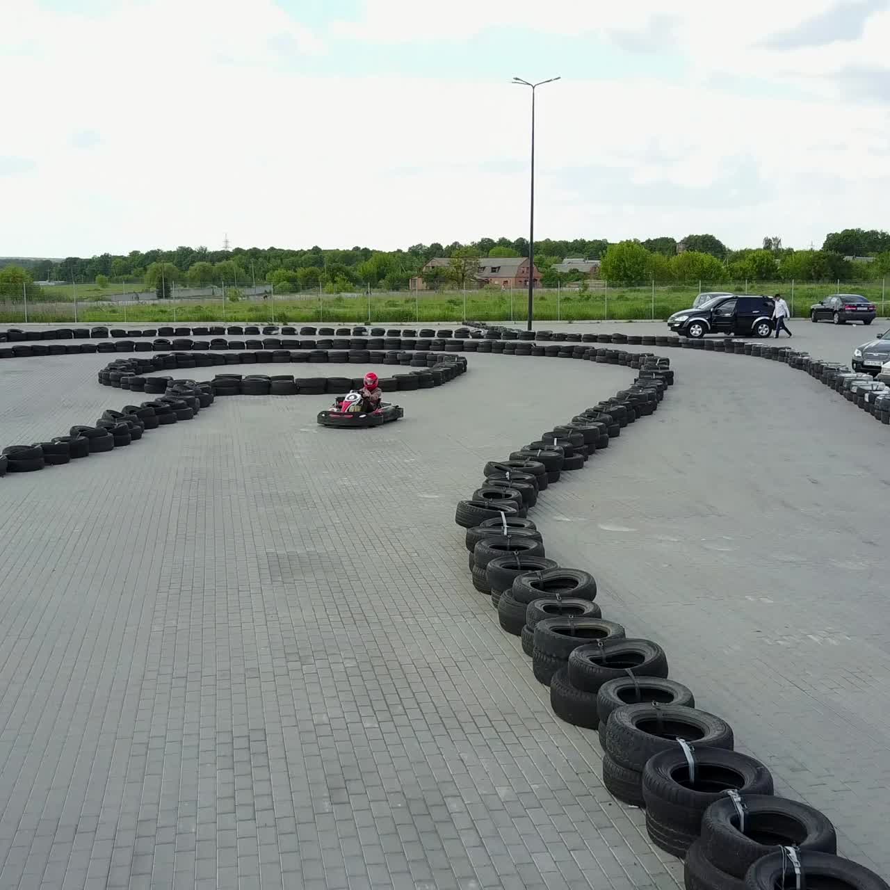 People Racing In Karts