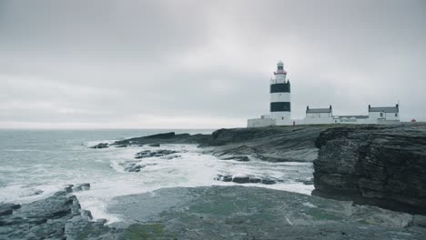 lighthouse at the stormy irish coast