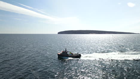 lobster fishing boat and crew from above with drone in slow motion 60fps in 4k