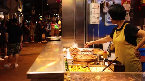 vendor preparing food at a bustling night market