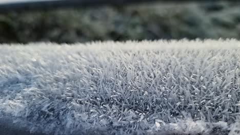 frozen frosty spikes natural pattern close up coating wooden fence in cold winter parkland