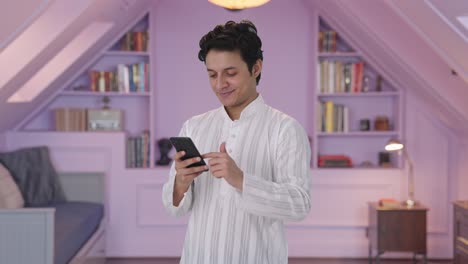 Happy-Indian-man-scrolling-phone