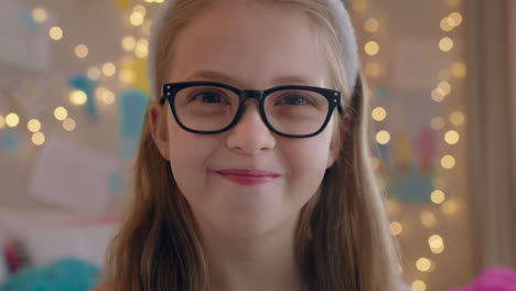 portrait nerdy little girl wearing glasses smiling happy looking at camera childhood concept