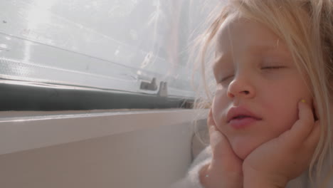 Serene-Child-Dreaming-on-Sunlit-Bed-Inside-Camper