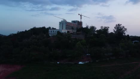 premiere hotel ibadan rebuild on mokola hill, a historic and iconic site in nigeria. stunning view of construction on hilltop as drone fly closer in countryside nigeria, africa