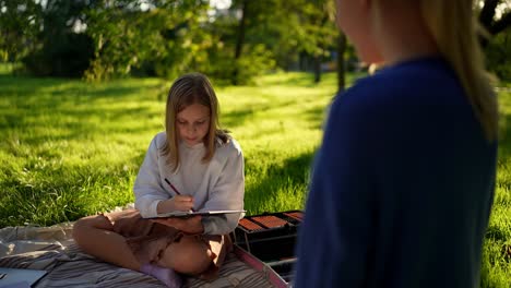 girl drawing in park