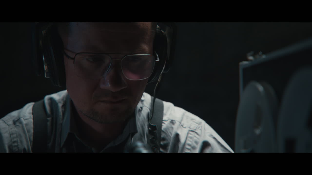 An intelligence officer listens to the wiretap recordings