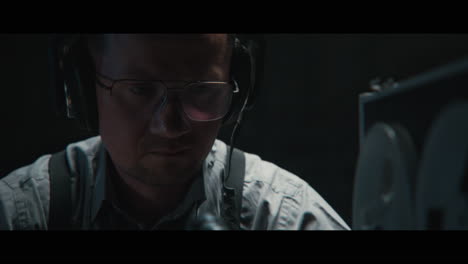 an intelligence officer listens to the wiretap recordings