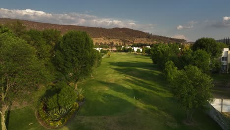 drone shot over a golf course at hacienda cantalagua in sunny contepec, mexico