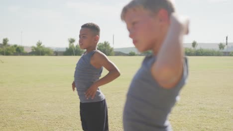 video of focused diverse boys practicing yoga on sunny day