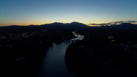 aerial footage flying towards the sawtooth mountain in the dusk of sunset over the sacramento river in redding, california