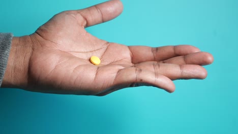 yellow pill in hand