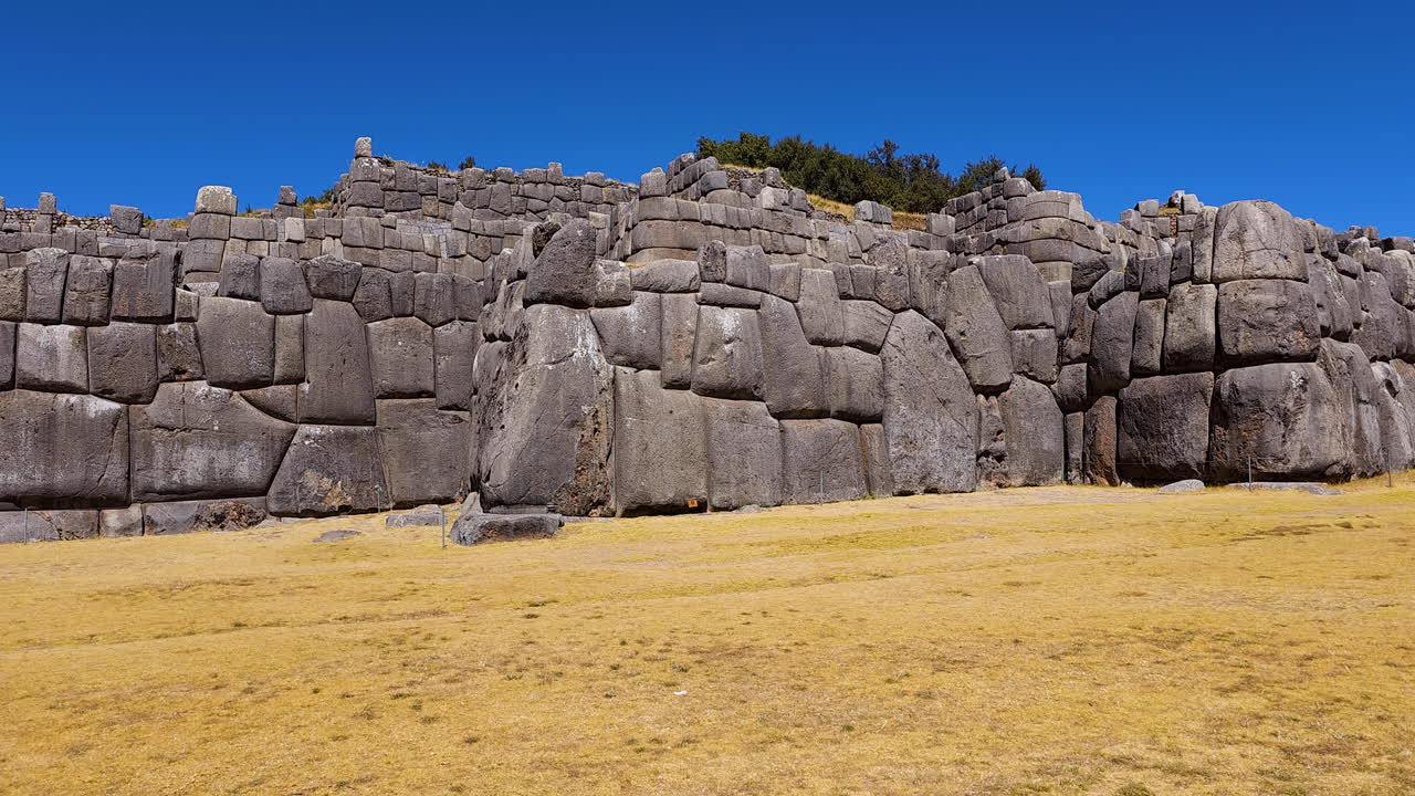 Monumental walls of Sacsayhuaman, an ancient Inca fortress in Cusco, Peru. This footage highlights the gigantic, perfectly fitted stones and the breathtaking scale of this historical site