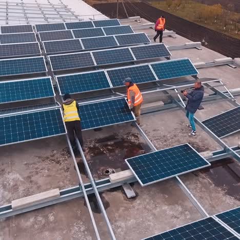 factory roof with solar panels. solar panels installing on roof of large industrial building