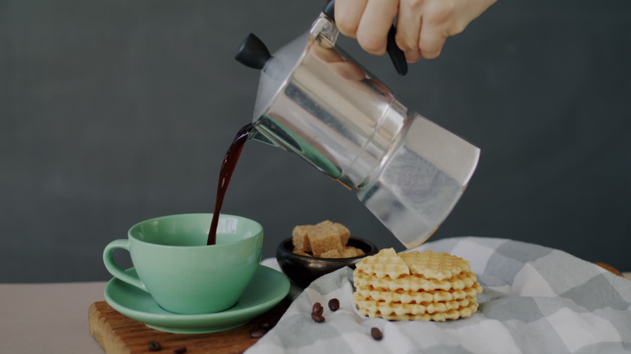 Pouring coffee with waffles and sugar
