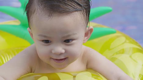 cute asian little boy playing water