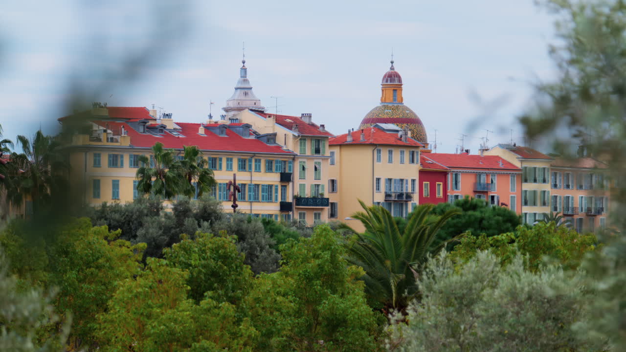 Colourful buildings and trees in the skyline of Nice, France on a cloudy day