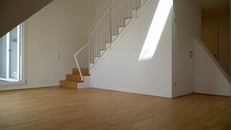 big, sunny living room with a staircase