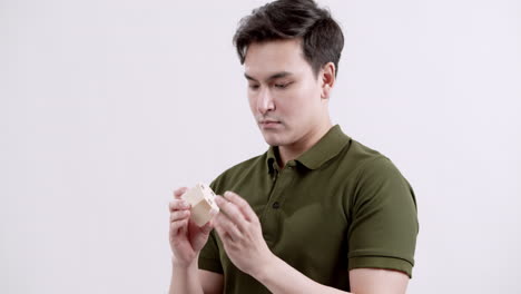 man solving a wooden puzzle