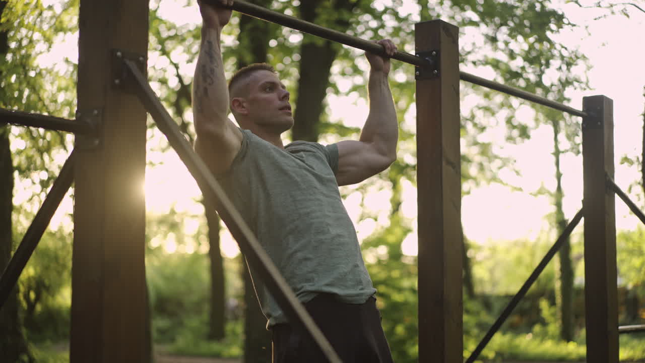 Man doing pull-ups in the park