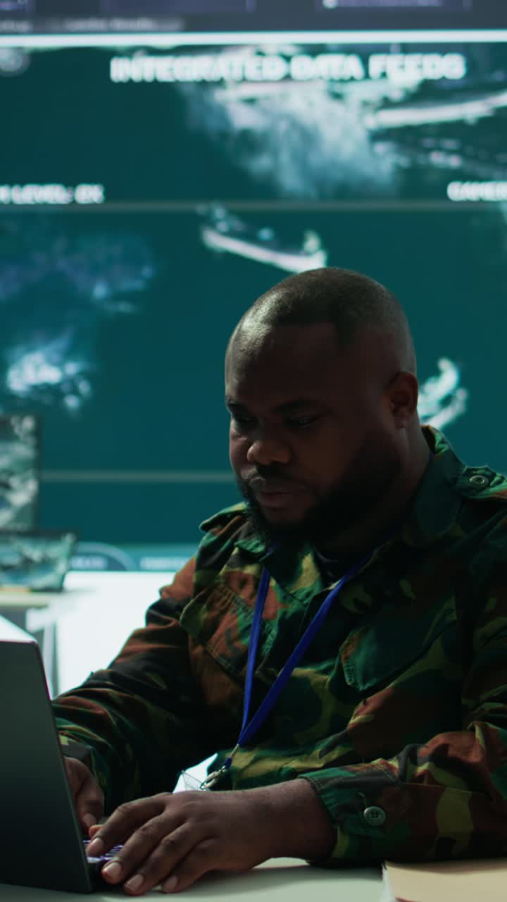 Vertical Video Military intelligence specialist uses high tech satellite systems and cctv radar