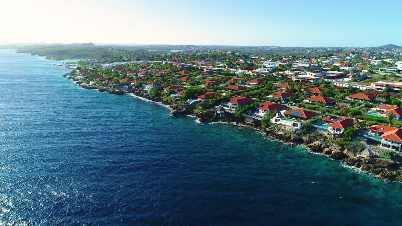 Stunning coastal view of curacao homes overlooking deep blue caribbean waters by Jan thiel boca gentil vista royal neighborhoods