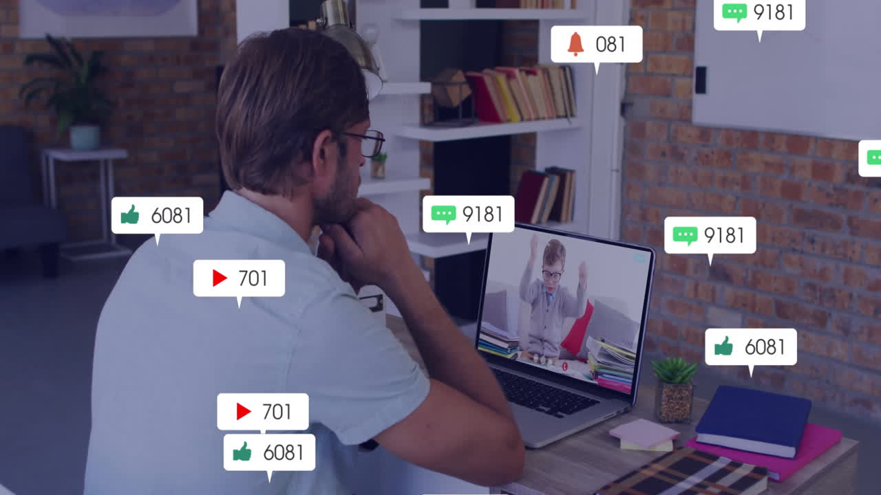 Watching animation on laptop, man receiving social media notifications at home