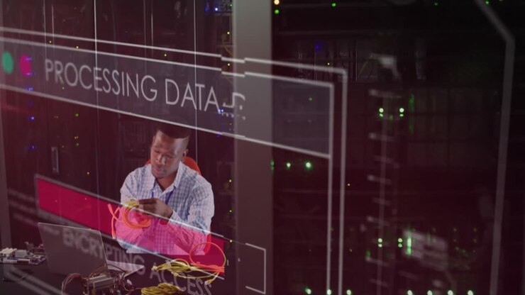 Animation of data processing over african american working on laptop in server room