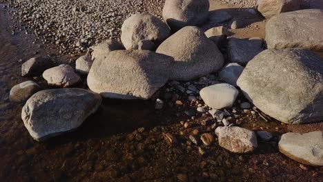 rocky beach shore with many boulders and blue sea nordic nature