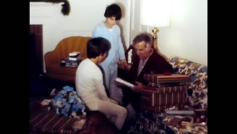 group of people standing around a 1970s living room. circa usa - 1970s: several individuals standing together in a 1970s living room, engaging in conversation and socializing.