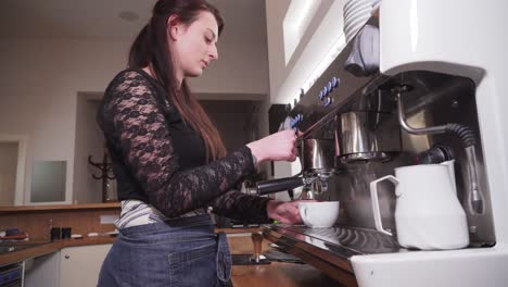 girl making coffee with lever maker, using steam to froth milk cream, wide angle closeup