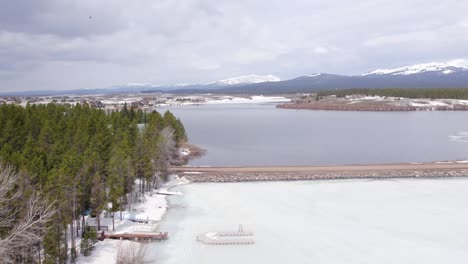 drone aerial of the winter showing the vacation homes around island park reservoir in island park idaho