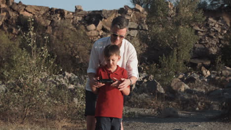 father and son flying a drone
