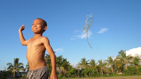 boy flying a kite in rural setting