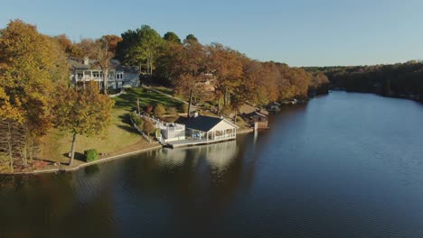 Ascending-aerial-reveal-from-lake-shore-boat-house