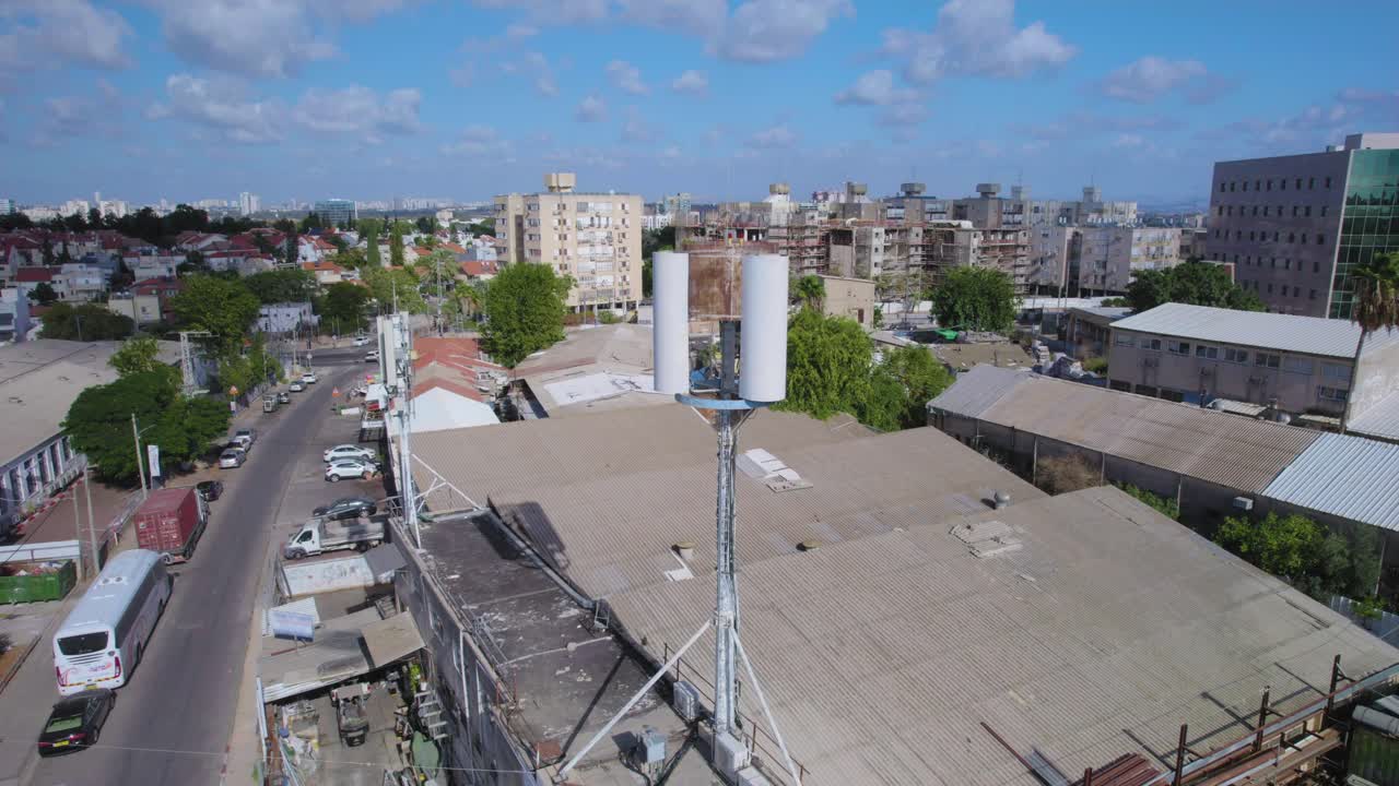 Close-up on monopole Cell phone tower Hidden antenna on a building in a small industrial area for mobile devices - The cell site transmission equipment is installed in the lease area or compound