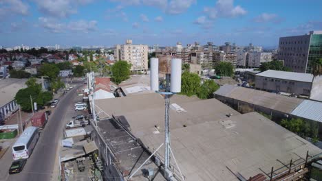 close-up on monopole cell phone tower hidden antenna on a building in a small industrial area for mobile devices - the cell site transmission equipment is installed in the lease area or compound
