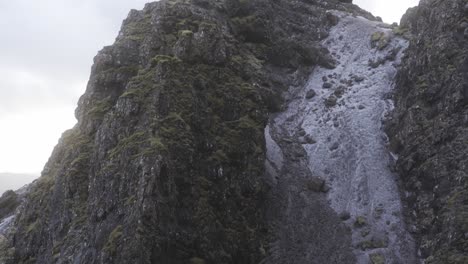 a close up panning shot showing the enormousness of old man of storr, isle of skye