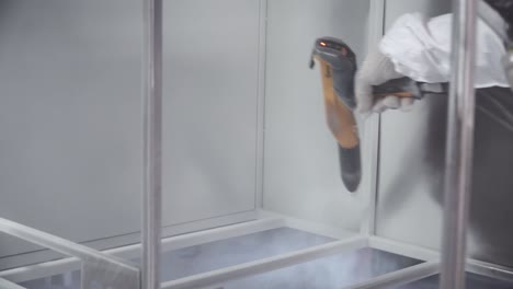 powder coating metal frames in a paint booth