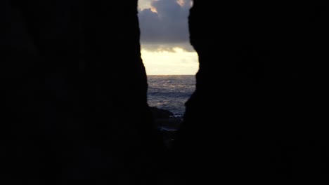 a stunning view of the sunset through rocks in the islands of fiji - wide shot
