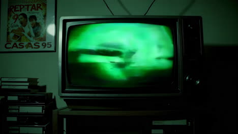 vintage tv with static and vhs tapes