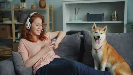 woman relaxing on sofa with dog