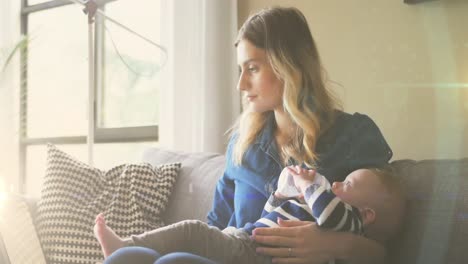 animation of glowing spots over caucasian mother with baby with drinking milk