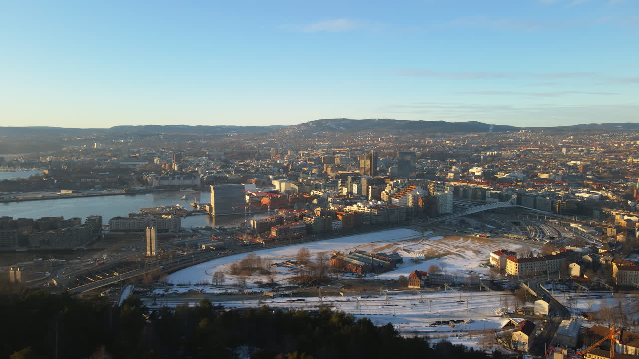 Drone shot of Oslo, Norway where we look over the whole city on a bright sunny day in the winter