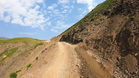 pov driving on 4wd black bear pass trail cut into a steep mountainside with no guardrail