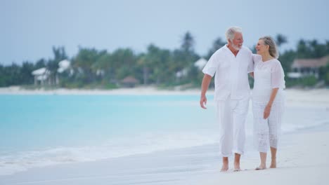 male female senior caucasian beach couple wearing white