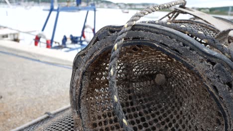 harbour close up stacked lobster pots on coastal marine waterfront dolly left