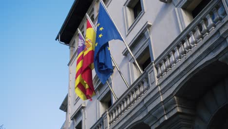 spanish and european union flags on a building